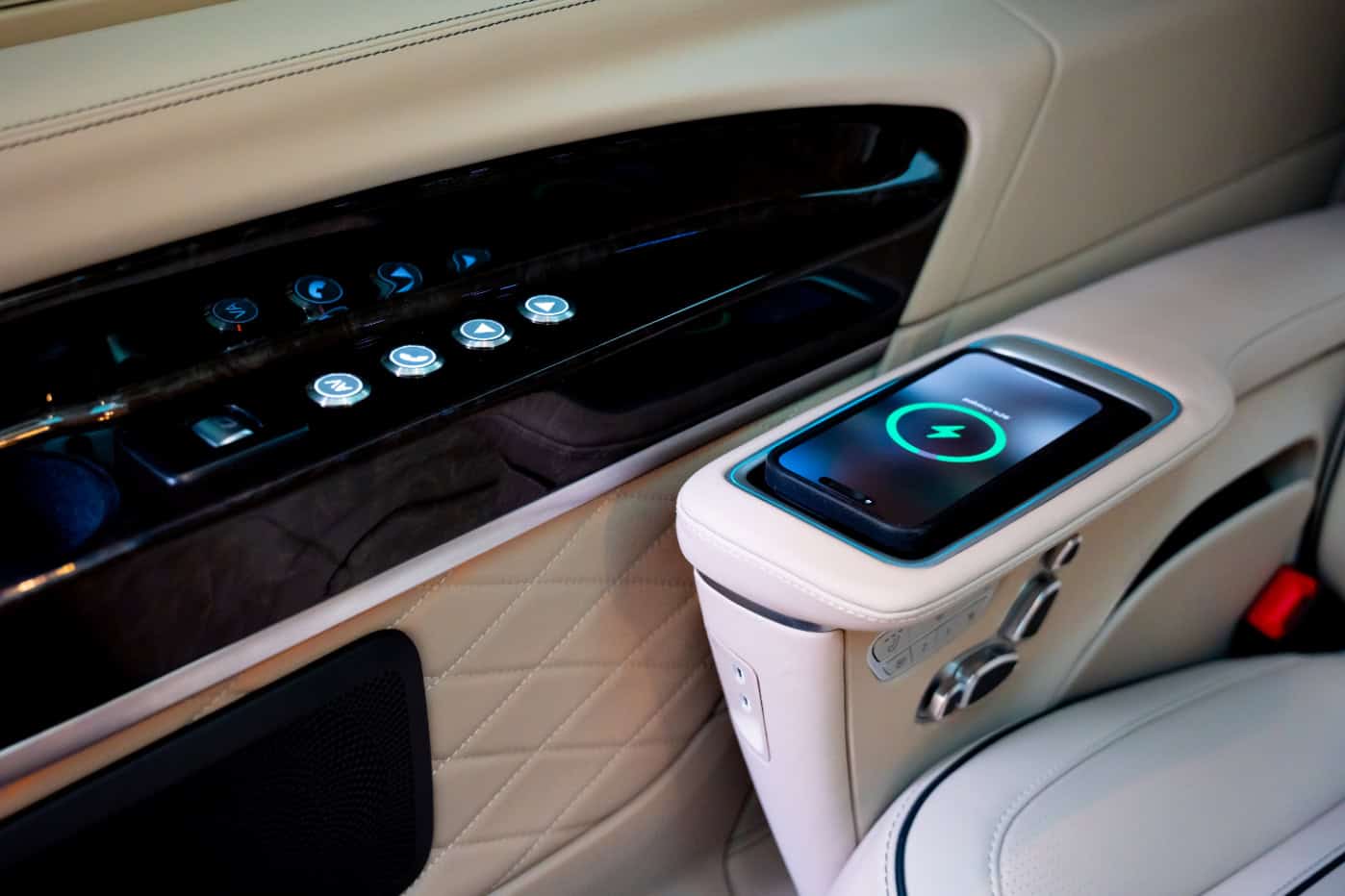 Luxury Car Interior with Wireless Charging Elegant car interior featuring wireless charging pad and control panel.