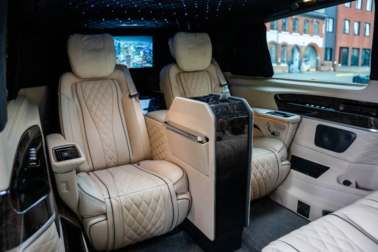 Swift Luxury Travel-19 Luxurious beige leather interior of a private jet with plush seats and ambient lighting.