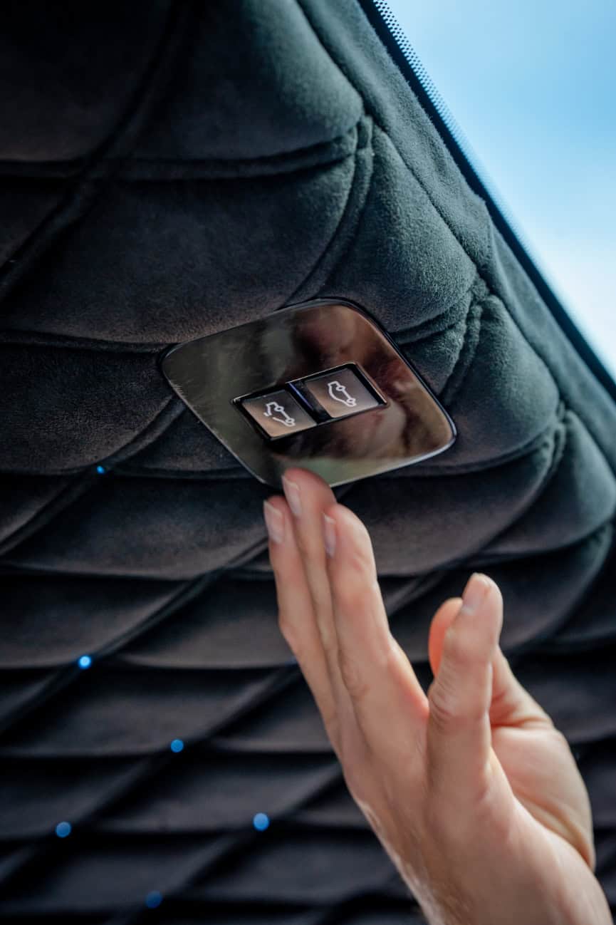 Swift Luxury Travel-49 Passenger pressing the call button on an aircraft seat's overhead panel.