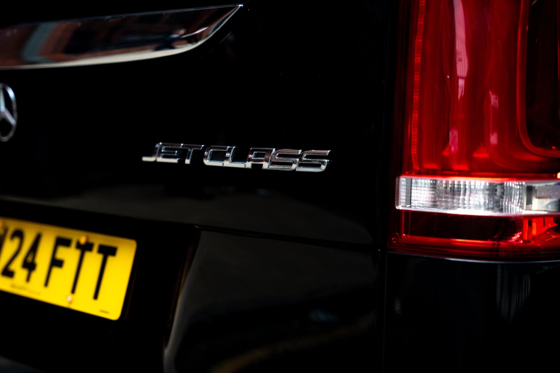 Swift Luxury Travel-60 Close-up of a black Volkswagen Jetclass vehicle with a yellow UK license plate.