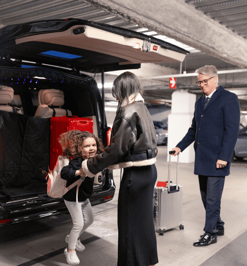 Swift Luxury chauffeur loading luggage for a Gatwick airport transfer