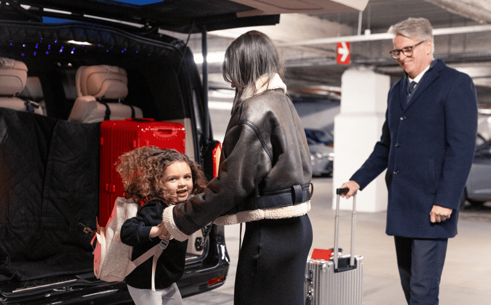 Swift Luxury chauffeur meeting passengers and helping with luggage for a Gatwick airport transfer